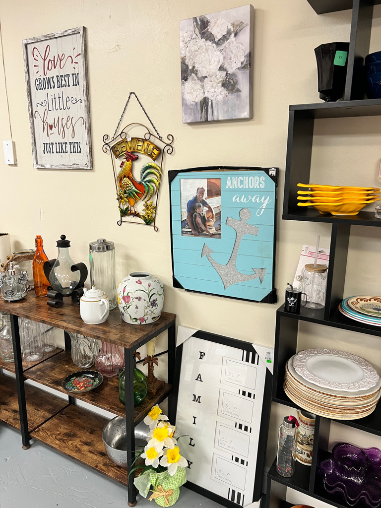 Home goods and artwork displayed inside The Rescue Thrift Shop